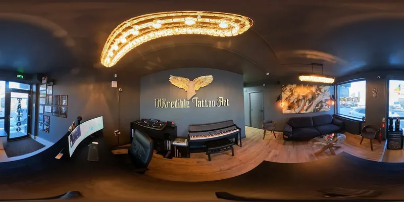 INKredible reception with gold winged logo and a piano